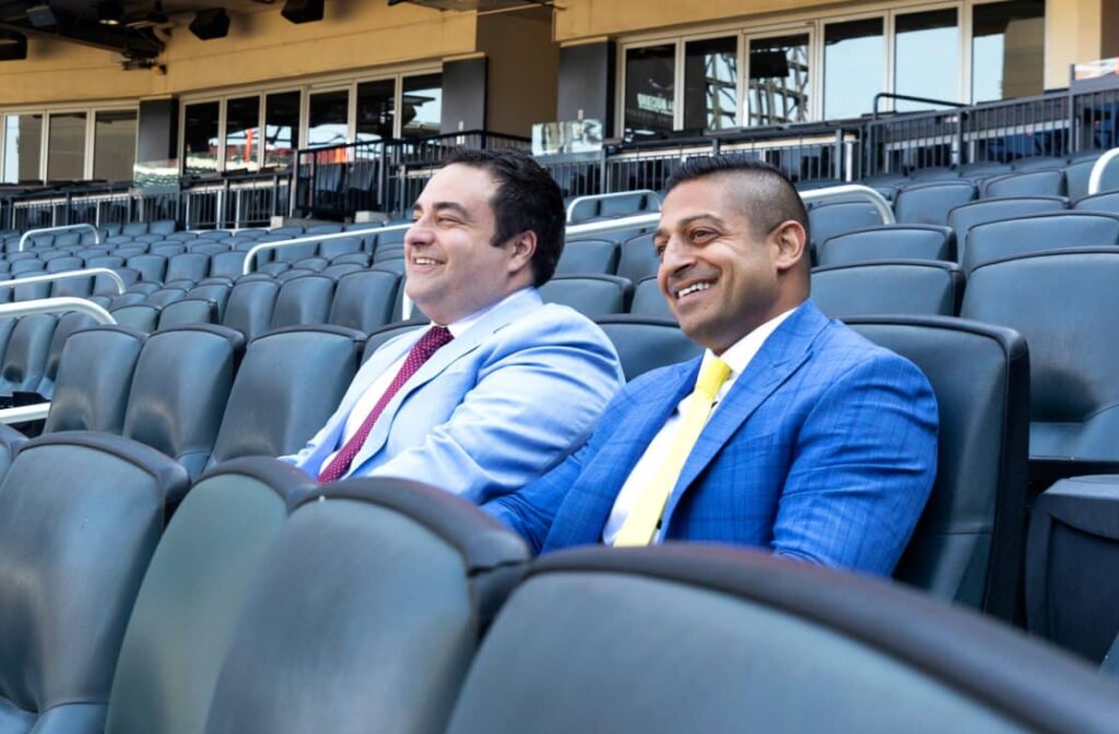 New York Personal Injury Attorneys - Alex Nocerino and Sameer Chopra sitting in an empty Mets stadium