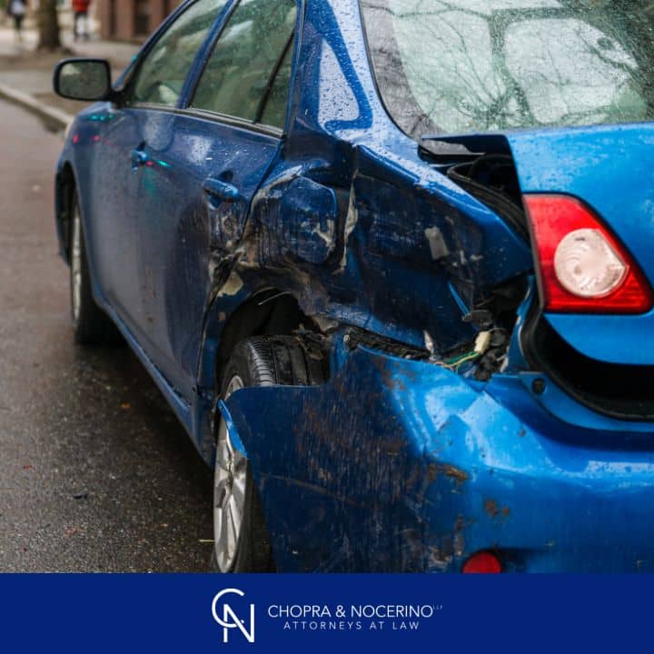 This image shows a blue car that was rear-ended in a hit and run accident.