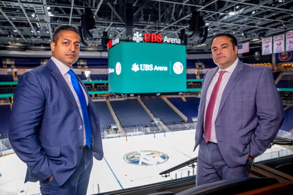 Sameer Chopra and Alex Nocerino at the UBS Arena in front of the NY Islander ice rink