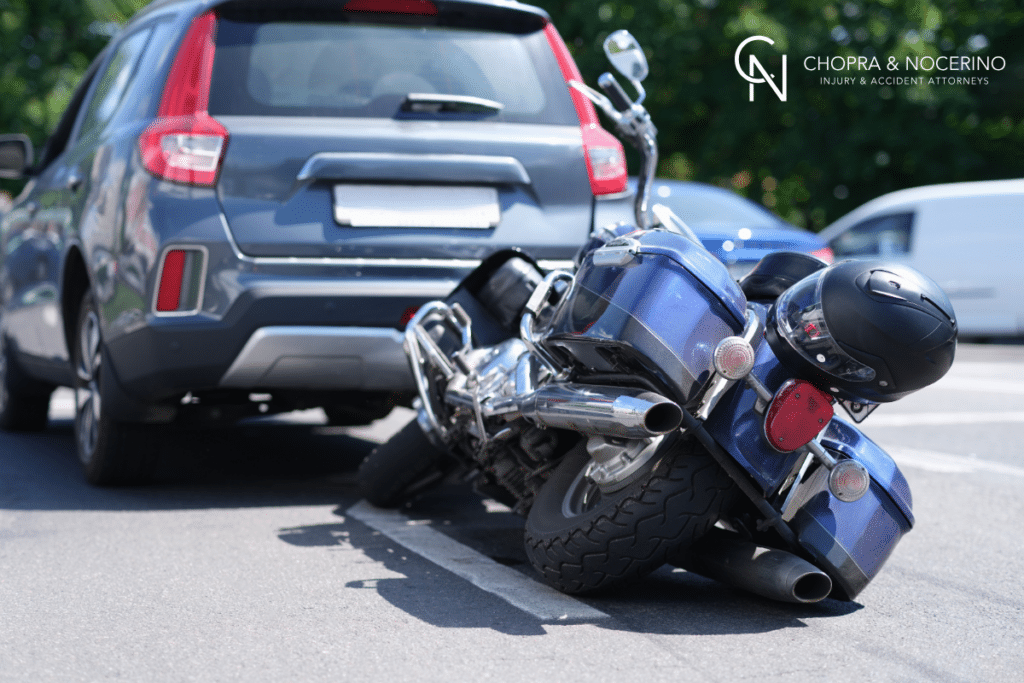 A motorcycle collided with the back of a car, resulting in an accident.