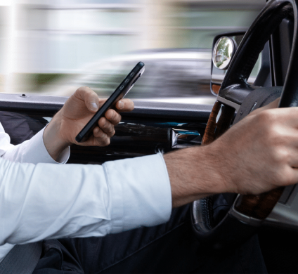 Man driving while texting on phone.