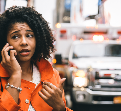 Woman on the phone, talking to someone about a car accident in New York